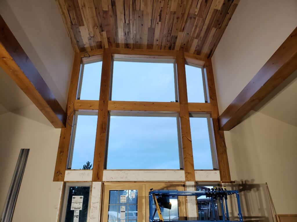 Wood-framed window with a scenic sky view in a cozy room.
