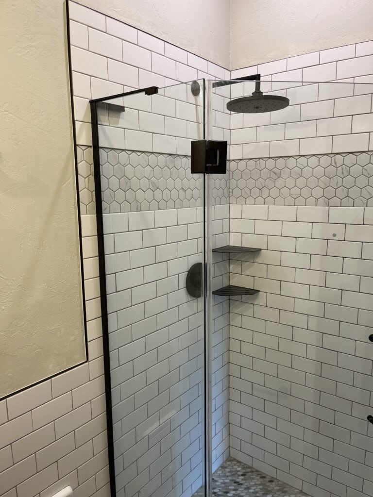 White tile walk-in shower with glass enclosure in Whitefish MT